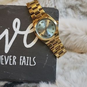 Gold Michael Kors watch with sky blue face.